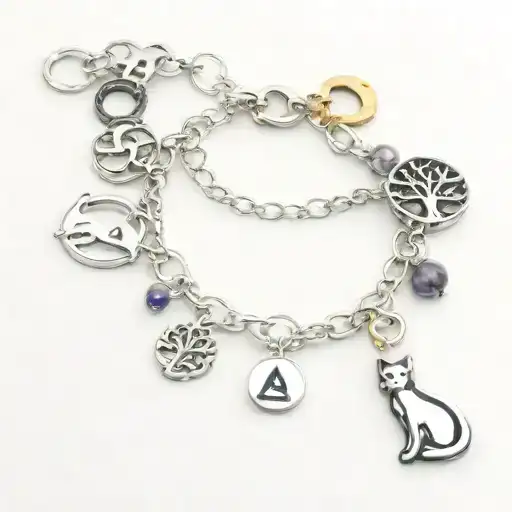charm bracelet with charms: cat sitting on moon, tree of life, capital letter A, lavender sprig, killer whale, infinity  tattoo design idea