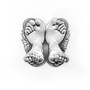 babies feet cupped in hands with angel wings and a pink rose tattoo design idea