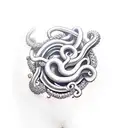 purple tentacle goes up from forearm to biceps where it catches sailing ship tattoo design idea