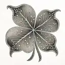 A unique and elegant four leaf clover with intricate dotwork details tattoo design idea
