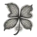 A unique and elegant four leaf clover with intricate dotwork details tattoo design idea