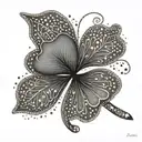 A unique and elegant four leaf clover with intricate dotwork details tattoo design idea