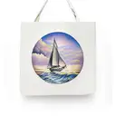 A traditional tattoo of a sailboat navigating through ocean waves under a setting sun tattoo design idea