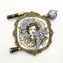 Square 1940s, hand mirror, lilacs intertwined, with a black and gold custom lipstick tube, and marbled black and brown c tattoo design idea