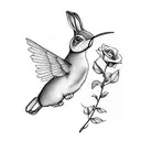a bunny with wings holding a flower for a hummingbird tattoo design idea