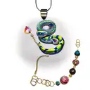 A ballpython snake wrapped around a Moana necklace tattoo design idea