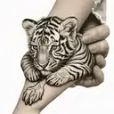 masked baby holding tiger tattoo design idea