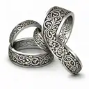 Interlocking wedding rings with intricate floral patterns intertwined tattoo design idea