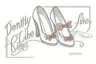 red outline of ruby slippers, the name Dorothy and the quote "There's no place like home" tattoo design idea