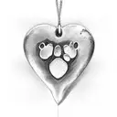 A heart-shaped pendant hanging from a dog paw print, representing love and loyalty towards pets tattoo design idea