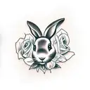 Black rabbit with floppy ears, flat and soft face running around flowers tattoo design idea