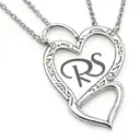 coquette open heart locket with letters R S inside tattoo design idea