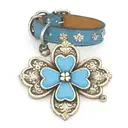 leather blue dog collar with paw prints and a knitwear four leaf clover charm tattoo design idea