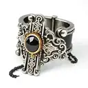 Black out line on a Finger ring of a rosary with the beads wrapped around the knuckles of the finger and the small cross tattoo design idea