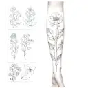 A sleeve tattoo featuring the birth flowers of February, March, April, May, September, and November in a dotwork style tattoo design idea