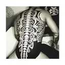 Incorporate Inca symbols into a blackwork tattoo of a spine, representing the importance of spinal health in osteopathy tattoo design idea