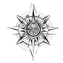 compass arrows with small lotus flower in bottom right hand corner tattoo design idea