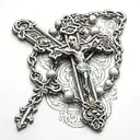 rosary with a cross around arm tattoo design idea