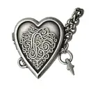 A heart-shaped locket with each family member's initials engraved on it tattoo design idea