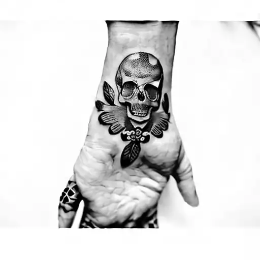 a hand with a skull and butterflies tattoo design idea