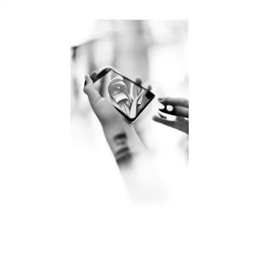 a person holding a cell phone tattoo design idea