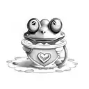 heart shaped mint green trinket box with a keroppi sticker on the top inside, with a small green glass blown frog tattoo design idea