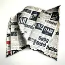 create a tattoo of a small torn piece of a newspaper with headlines and paragraph in black and some red in it tattoo design idea