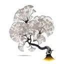ginkgo tree with a mountain underground for roots and leaves floating away from the tree tattoo design idea
